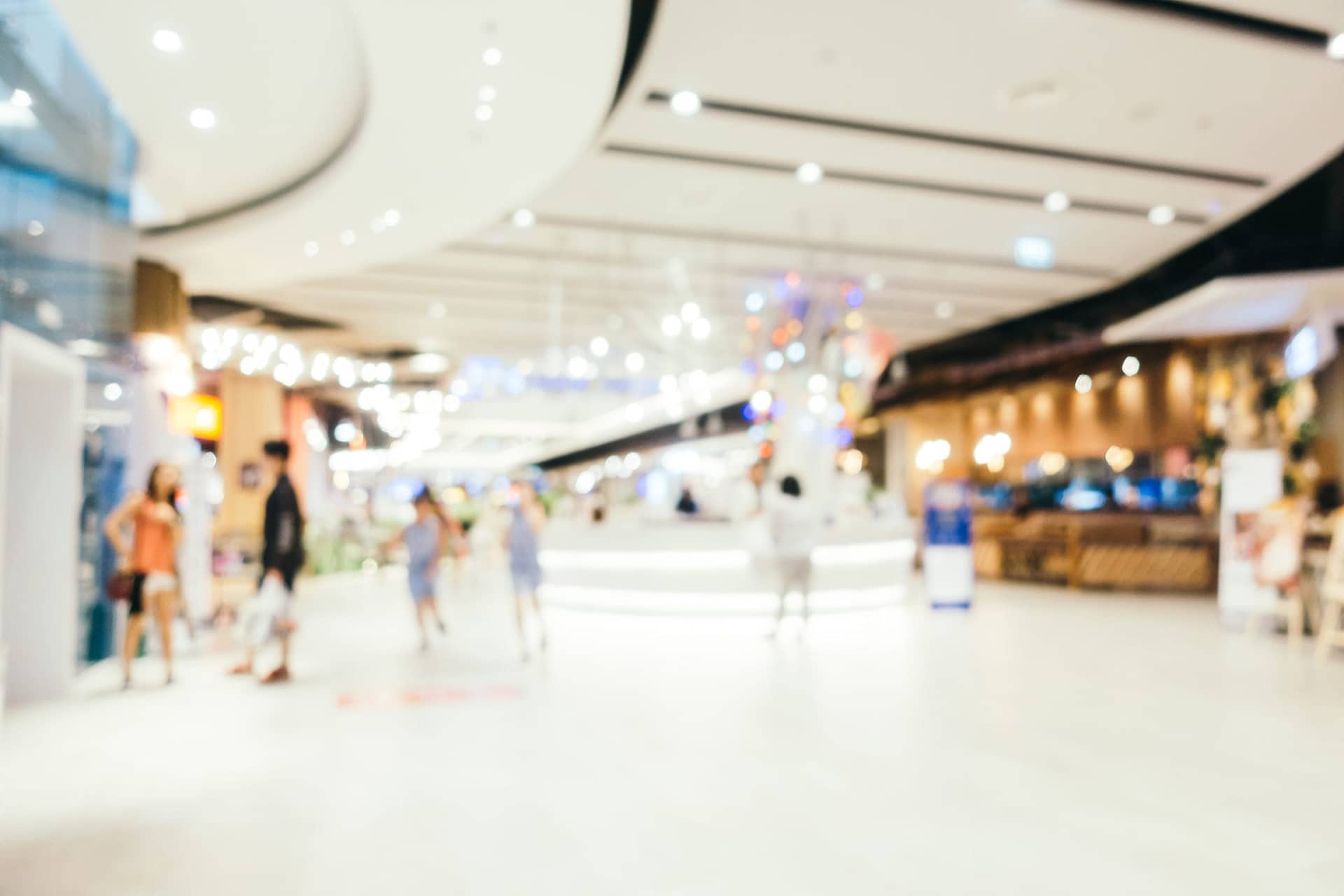 Abstract blur and bokeh defocused shopping mall interior of department store for background